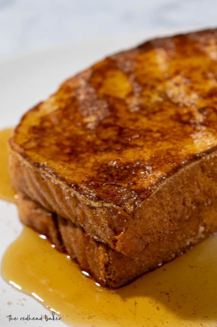 A close-up of two slices of churro French toast