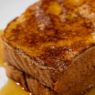 A close-up of two slices of churro French toast