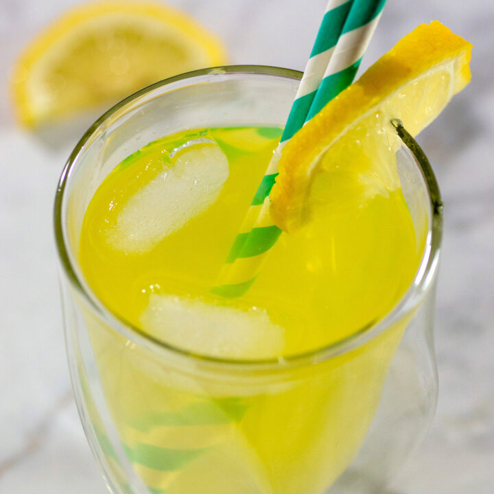 A glass of mango lemonade vodka cooler.
