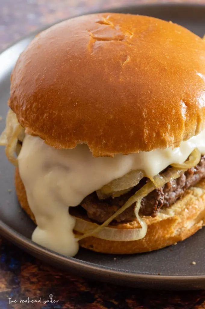 A Philly burger on a matte black plate