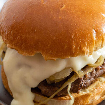 A Philly burger on a matte black plate