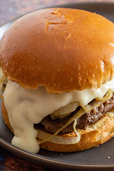 A Philly burger on a matte black plate