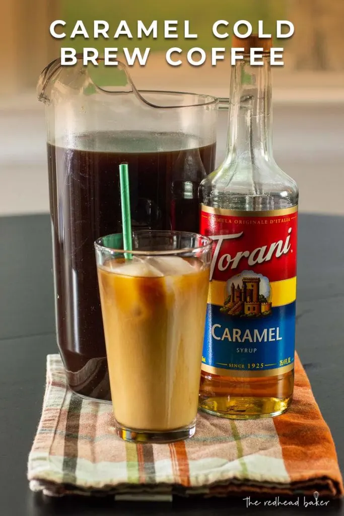 A pitcher of caramel cold brew with a bottle of Torani and a glass of cold brew
