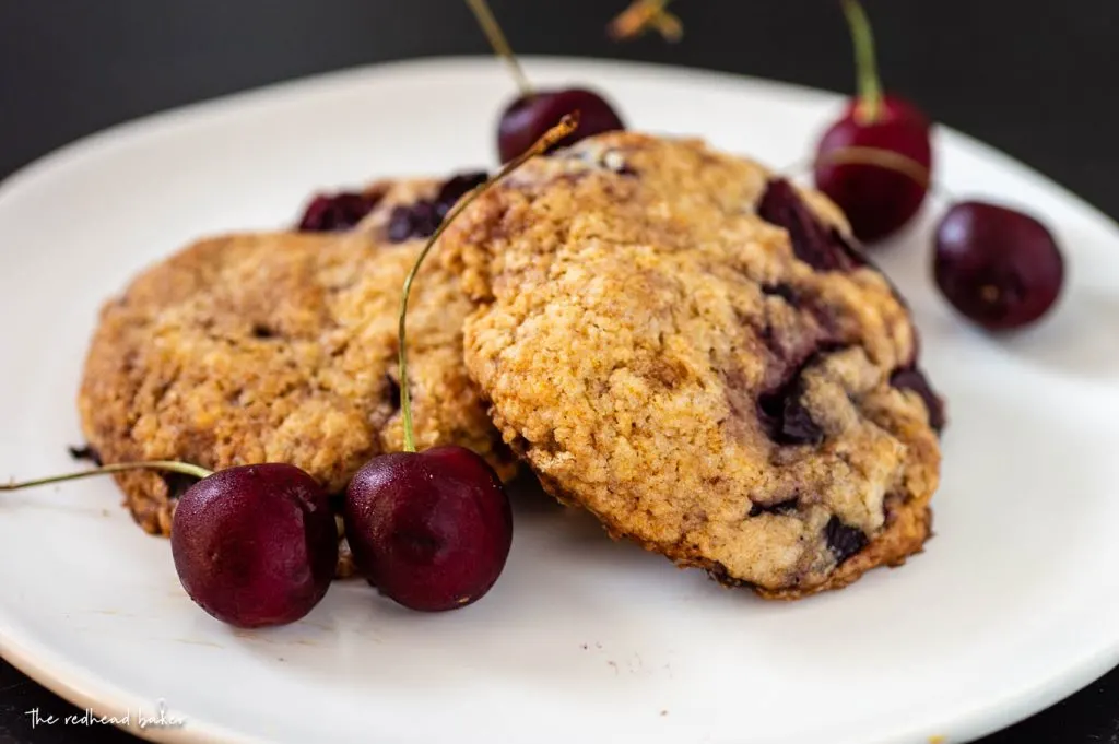 Cherry almond scones and fresh cherries on a plate