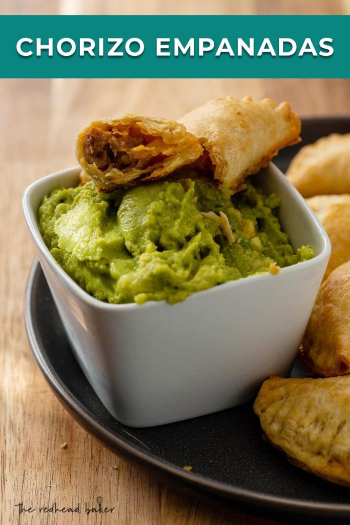 An open chorizo empanada over a bowl of guacamole