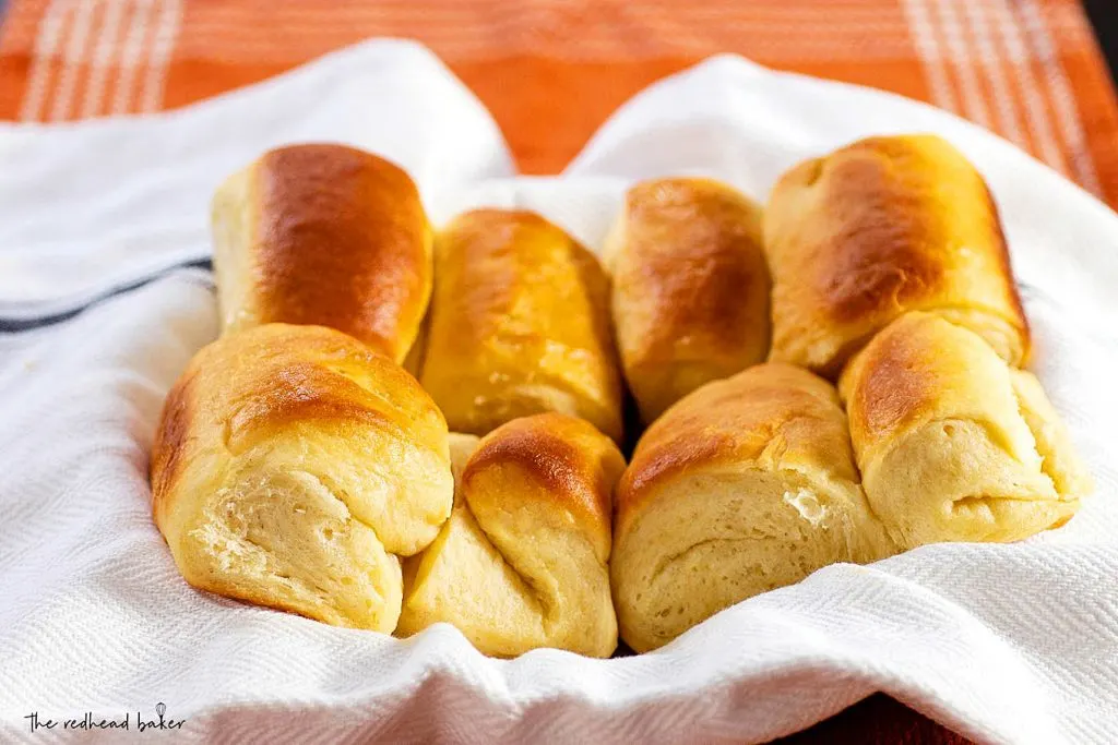 Eight Parker House rolls in a serving bowl