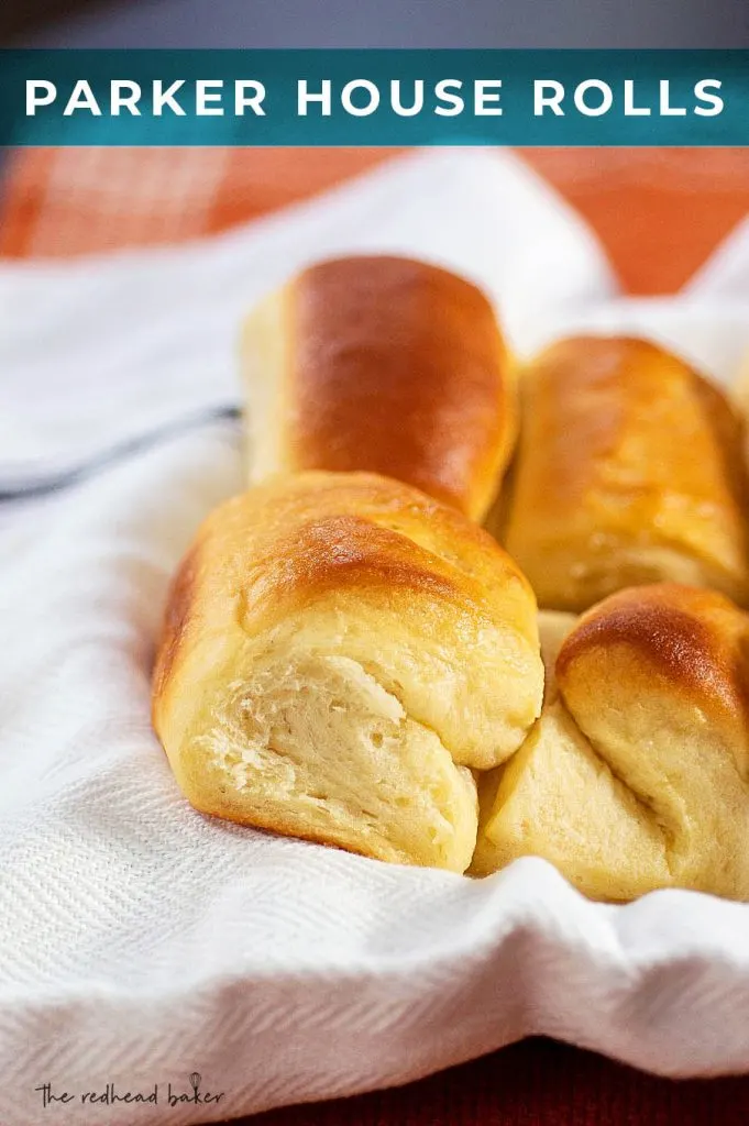 A close-up of Parker House rolls in a serving bowl