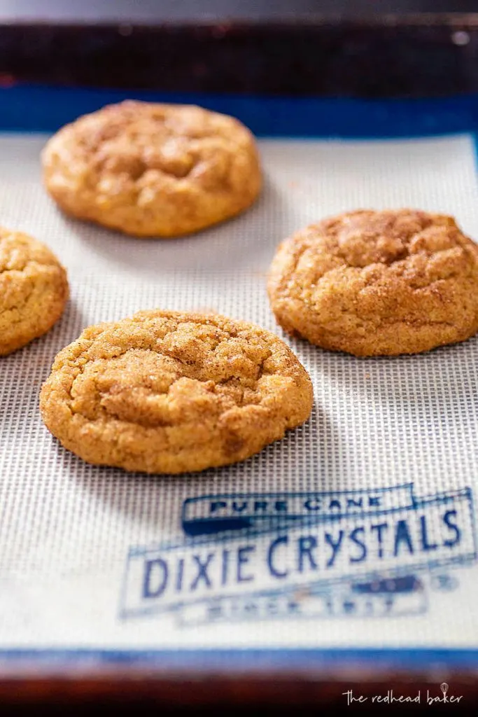 Baked pumpkin snickerdoodle cookies on a Dixie Crystals baking mat