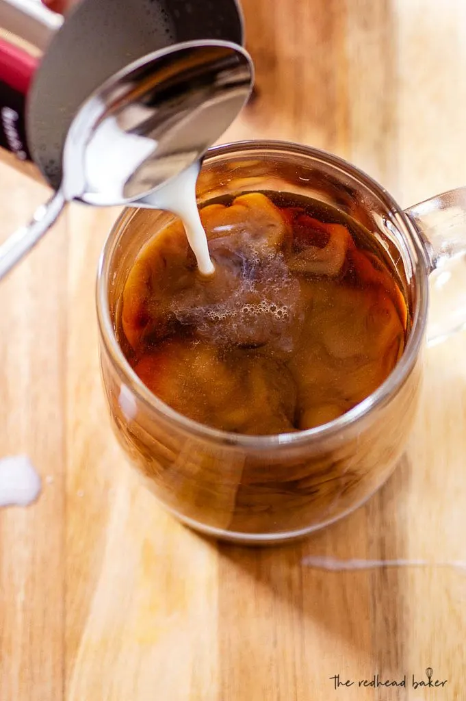 Foamed milk being poured into a pumpkin white chocolate mocha latte