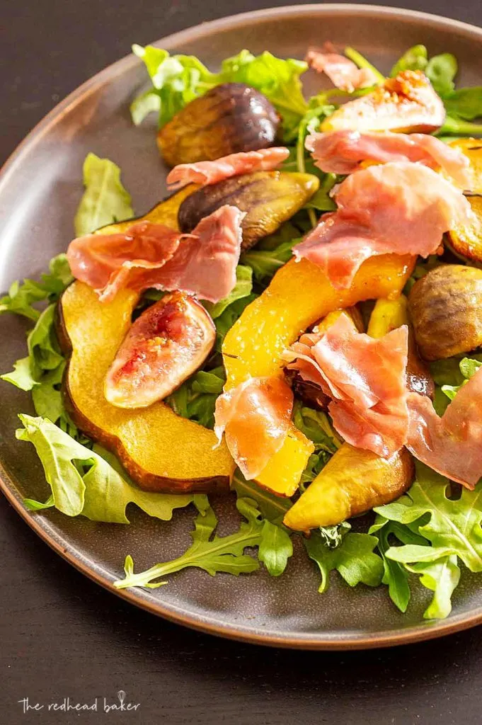 A high-angle view of a plate of roasted acorn squash and fig salad
