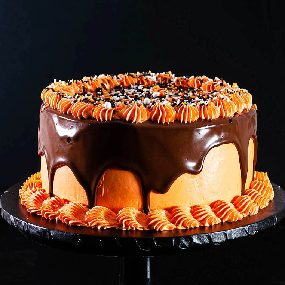 Halloween layer cake against a black backdrop.