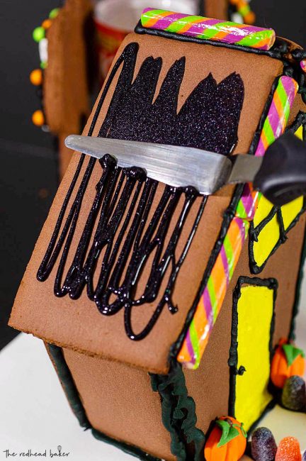 Wilton makes it easy to create a spooky haunted Halloween cookie house with kits, which includes pre-made cookie house pieces, trees, and candy decorations. You can also incorporate other Wilton products!