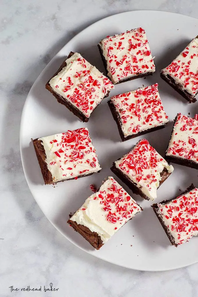 An overhead view of peppermint mocha brownies on a white plate