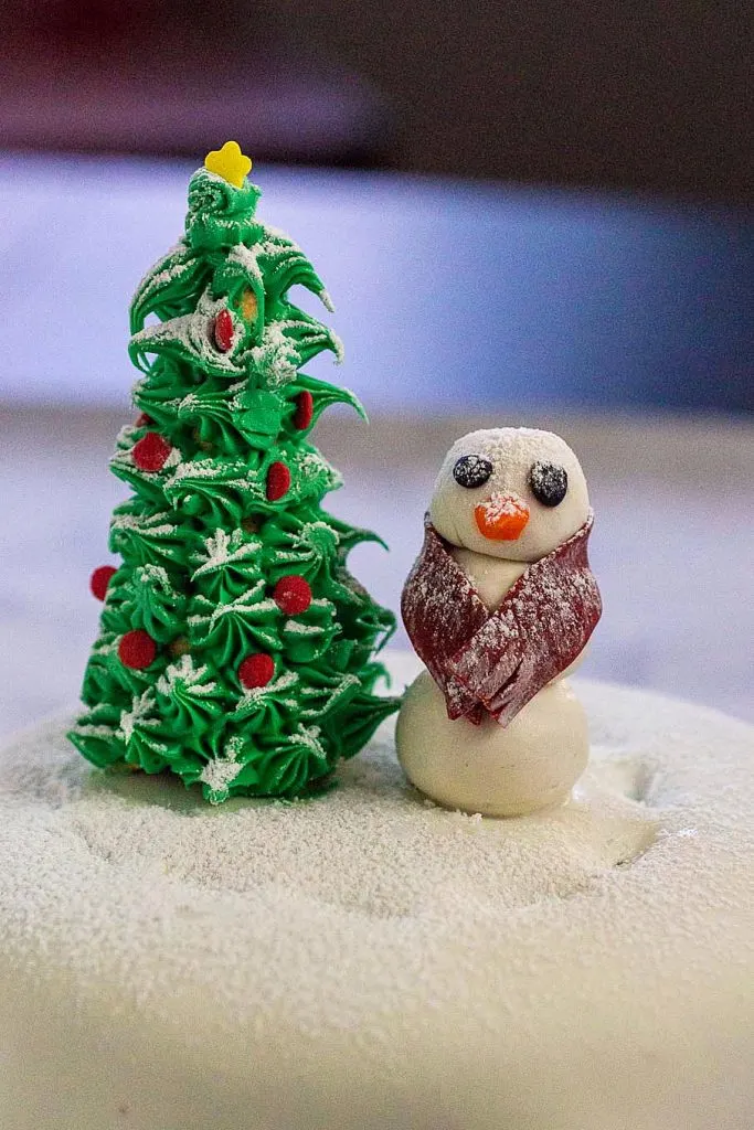 This adorable snow globe cake is a delicious centerpiece for your holiday dessert table. Large crowd? Make more than one!