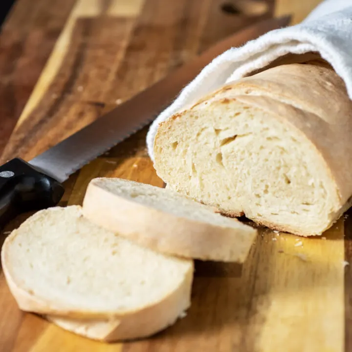 A loaf of Italian bread with two slices cut off.