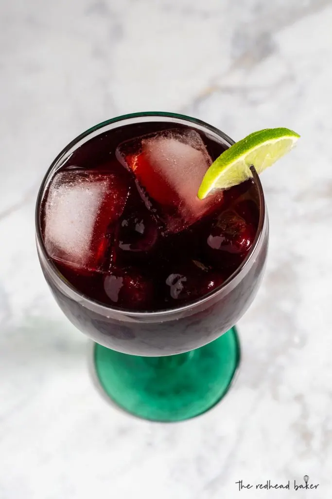 An overhead view of a cherry limeade margarita