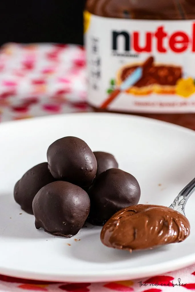 A stack of truffles next to a spoonful of Nutella