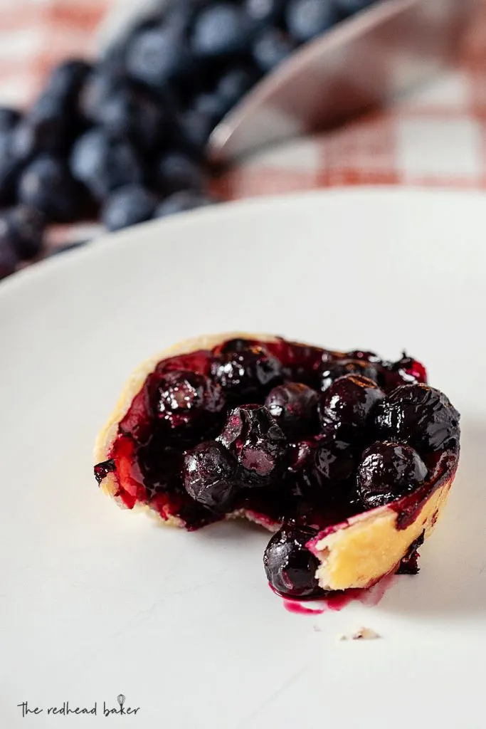 A mini pie with a bite taken out of it