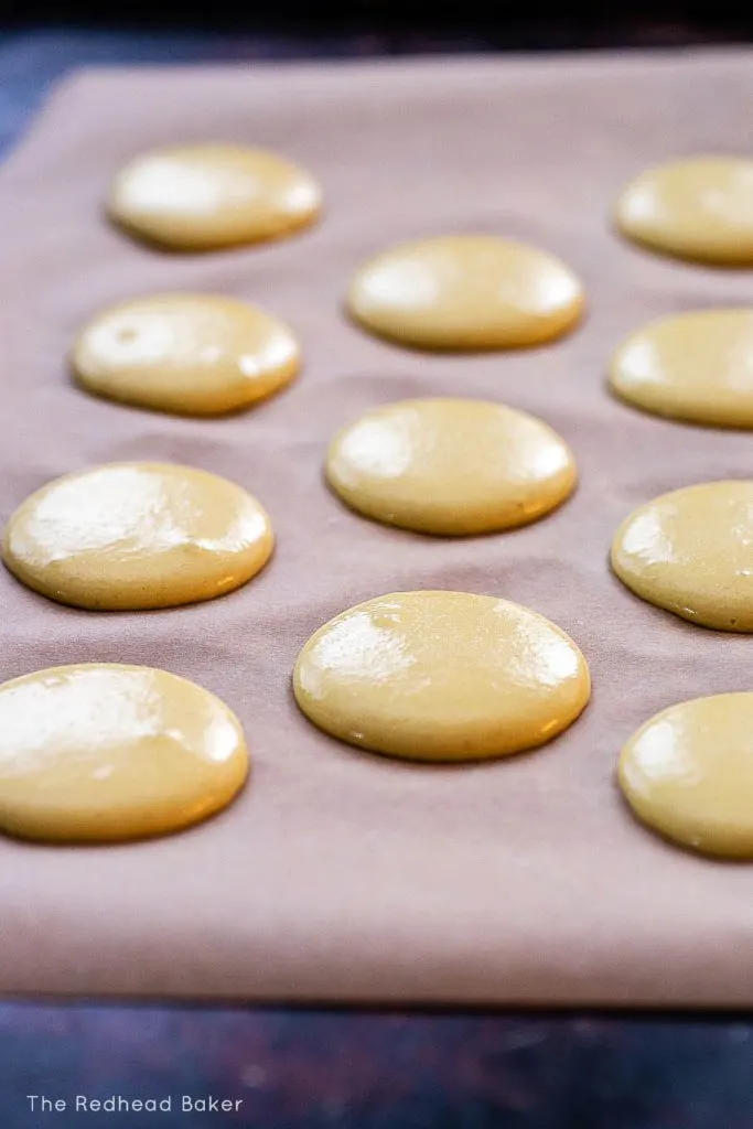 A sheet of macaron shells ready to be baked