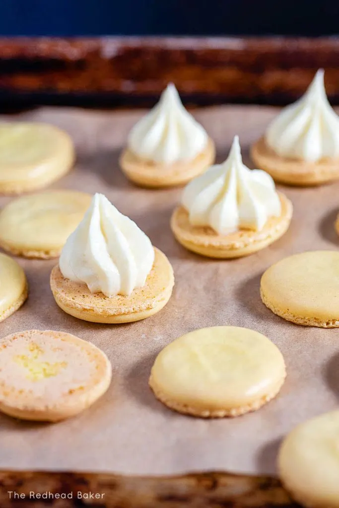 Baked macaron shells with dollops of lemon curd filling