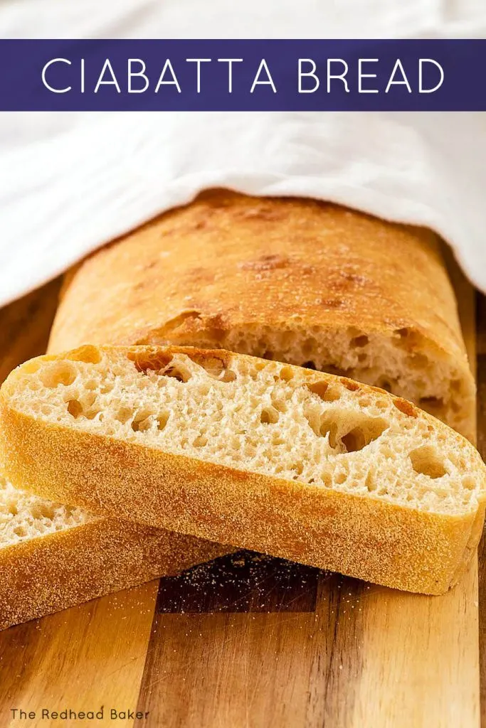 A cut loaf of ciabatta bread with two slices piled in front