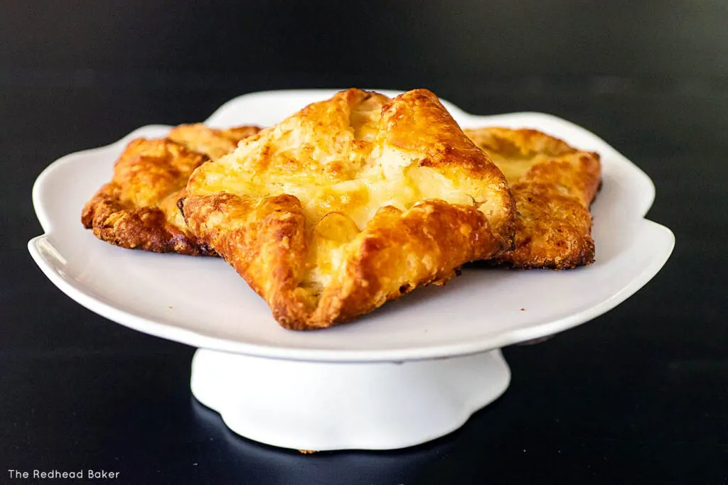 Three danish pastries on a cake stand