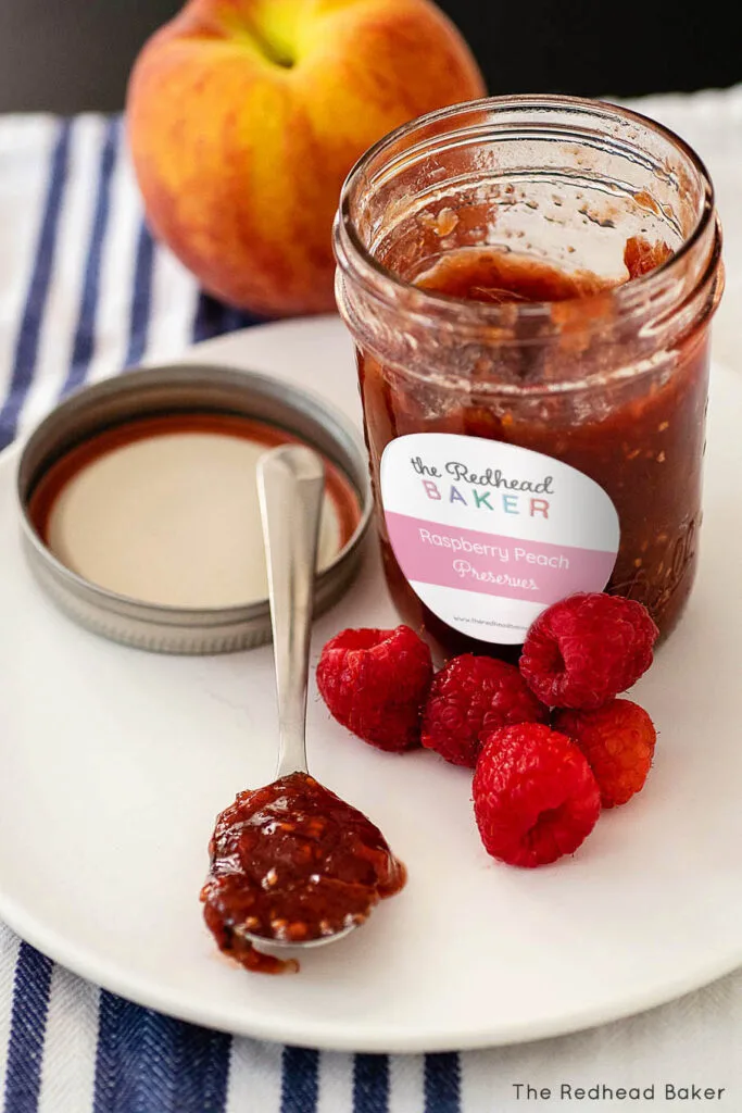 A spoonful of jam in front of an open jar