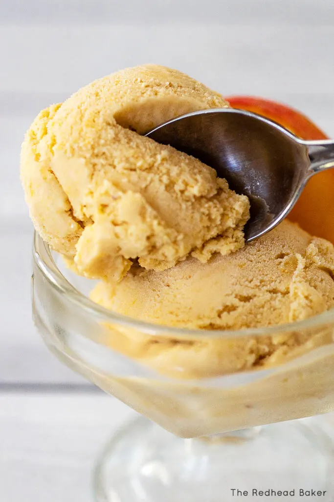 A spoon sliding into a scoop of ice cream