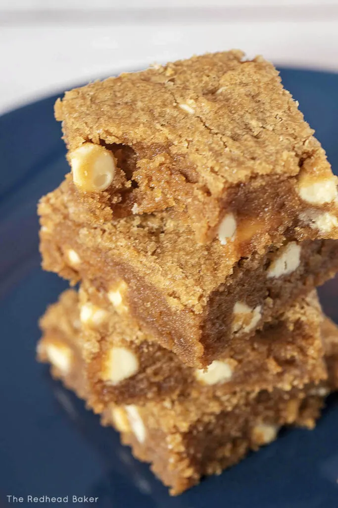 A top-down view of a stack of blondies on a blue plate