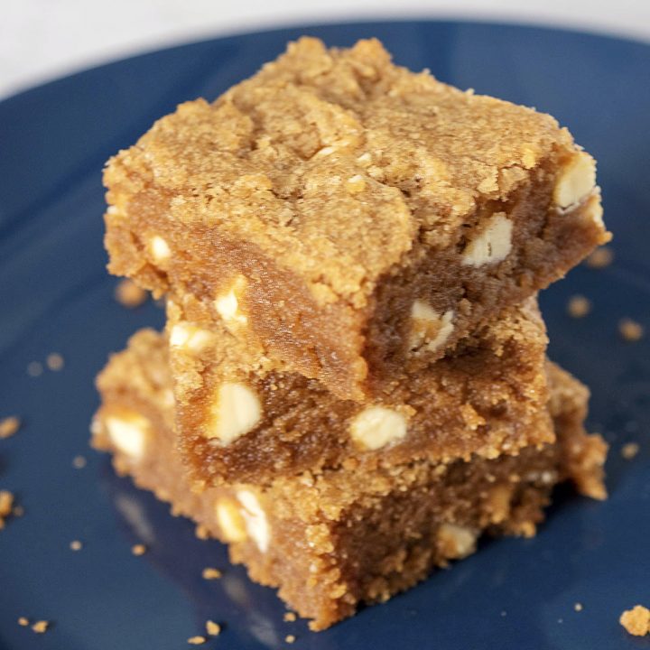 A stack of cookie butter blondies on a blue plate