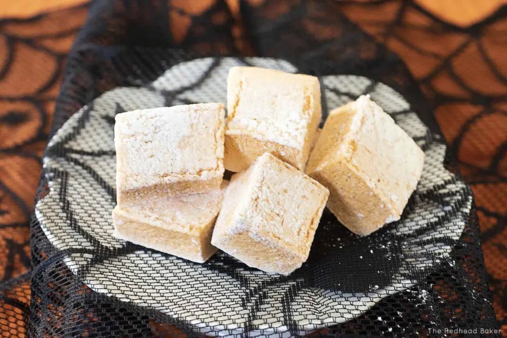 A pile of pumpkin marshmallows on a mini cake stand