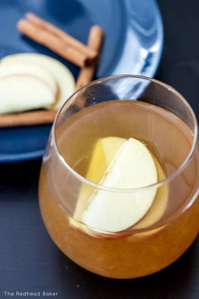 An overhead view of a glass of apple cider whiskey sour