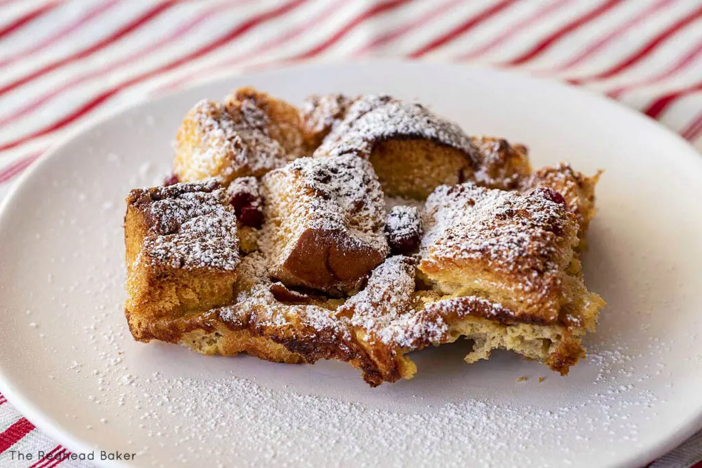 A plateful of cranberry eggnog French toast dusted with confectioners sugar