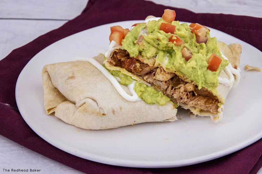 A chimichanga cut open to reveal the chicken filling