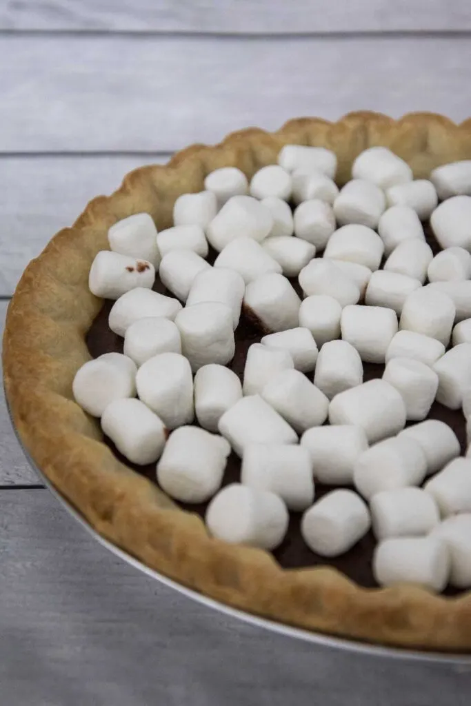 A s'mores pie with untoasted marshmallows on top