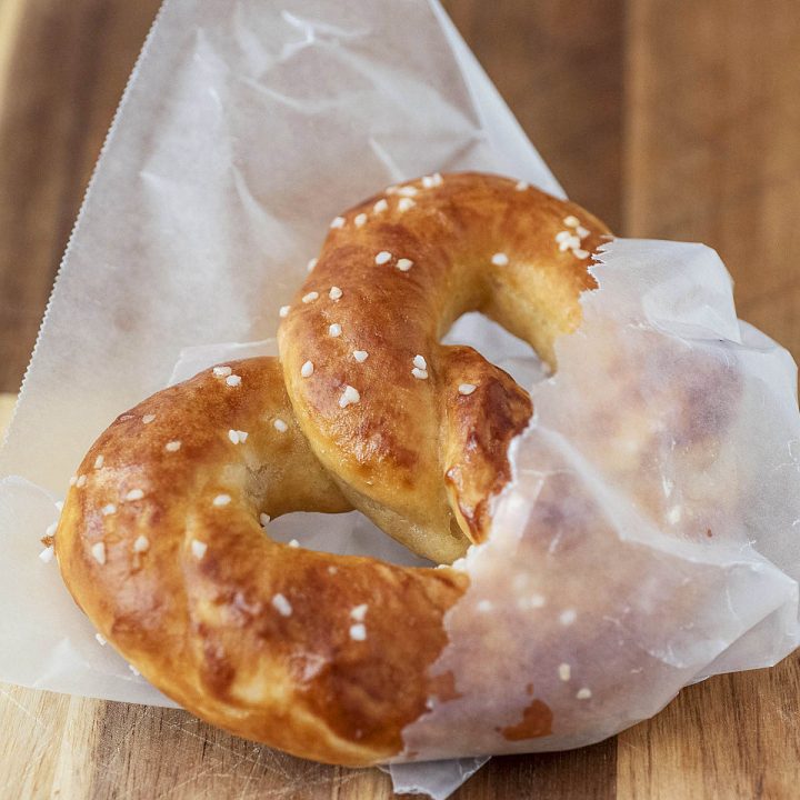 Soft pretzel wrapped in wax paper