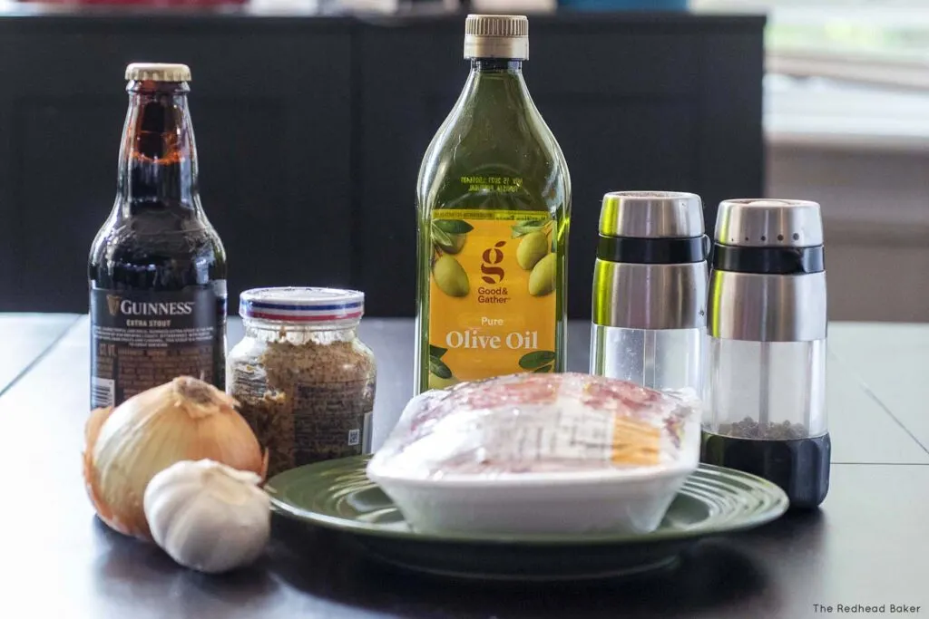 Ingredients for an Irish burgers: olive oil, salt, pepper, ground beef, garlic onion, Dijon and Guinness