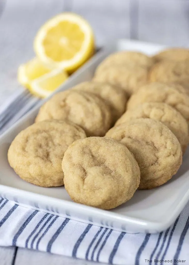 Lemon doodles on a white serving tray with a lemon half and two lemon wedges