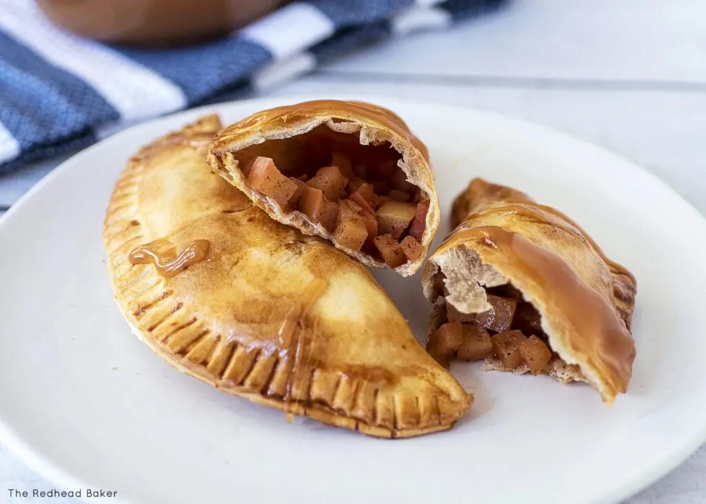 A close-up of an air fried empanada showing the inner apple filling.