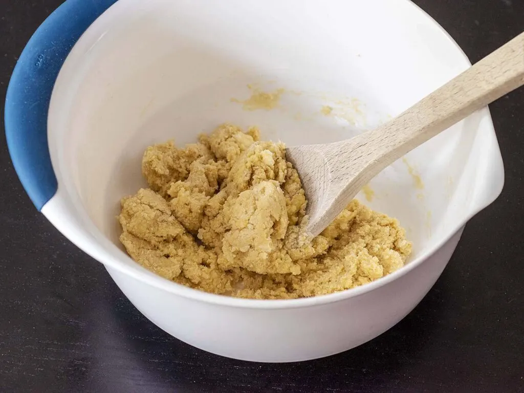 The mixed dough in a mixing bowl, after the eggs have been stirred in.