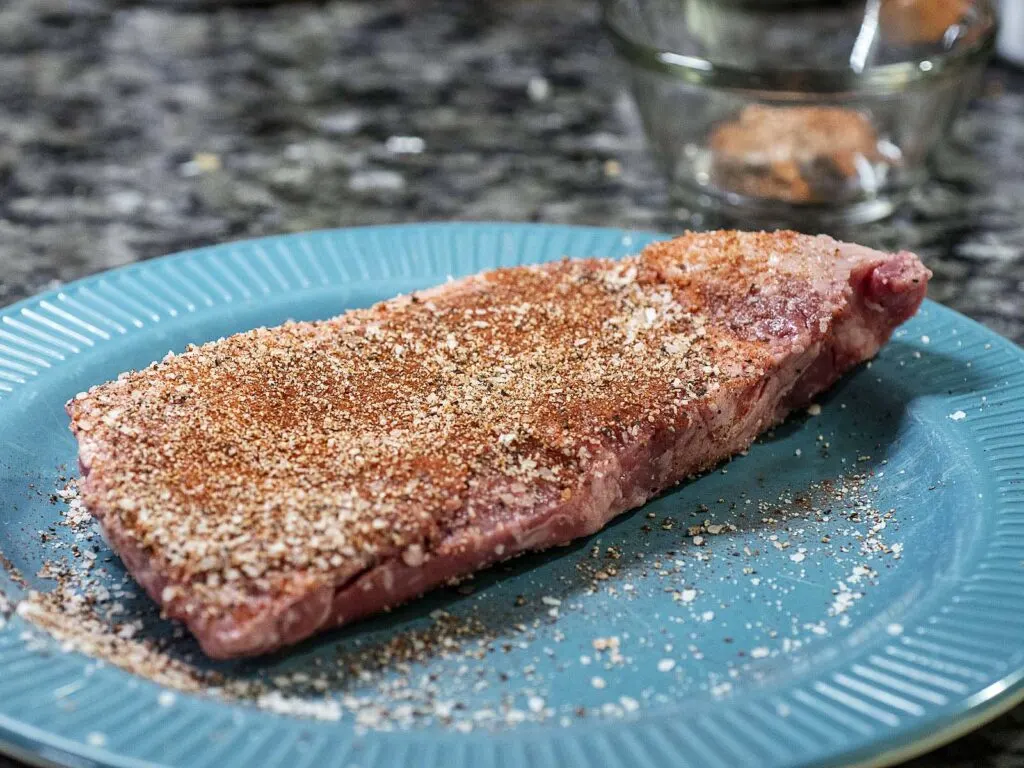 Ribeye steak seasoned with salt, pepper, paprika and garlic powder.