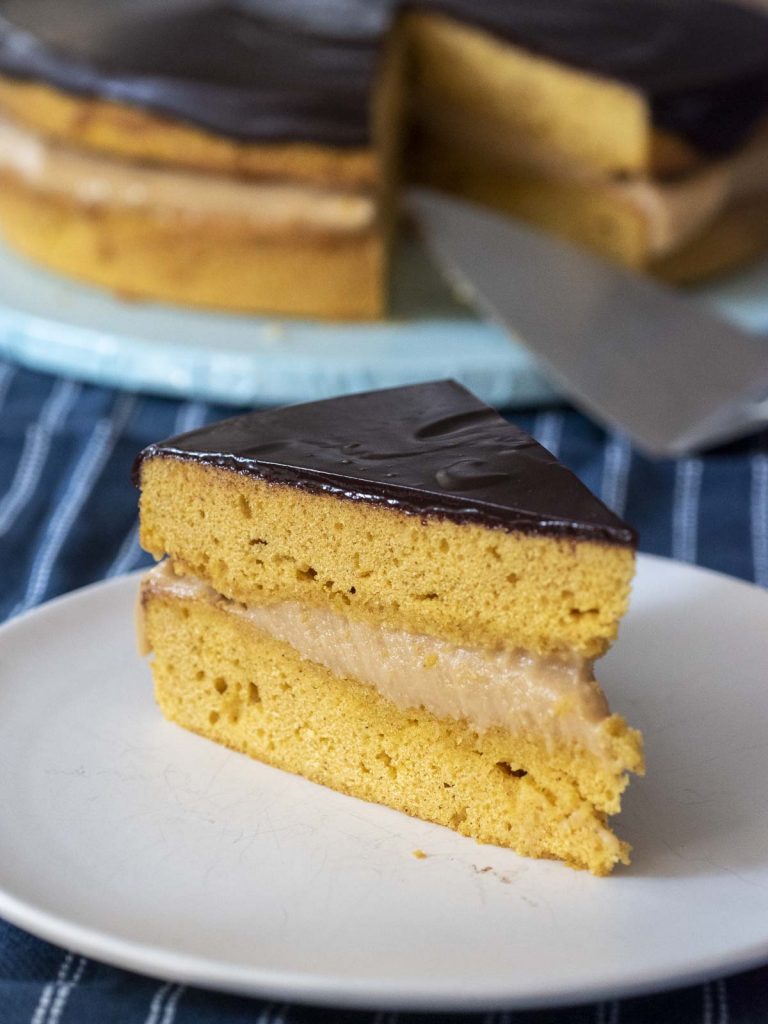 A slice of Pumpkin Boston Cream Pie on a white plate.