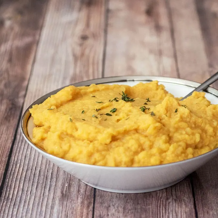 A bowl of pumpkin mashed potatoes.