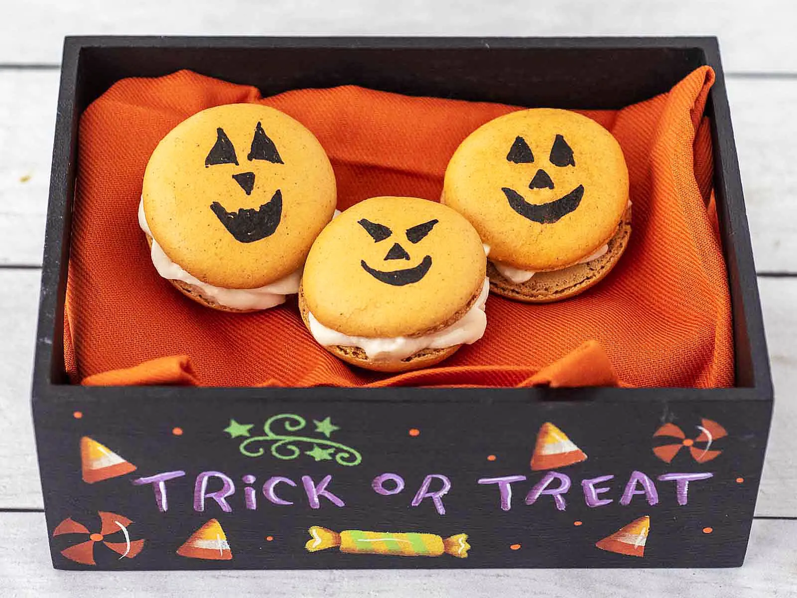 Three Halloween Macarons in a hand-painted Trick or Treat box.