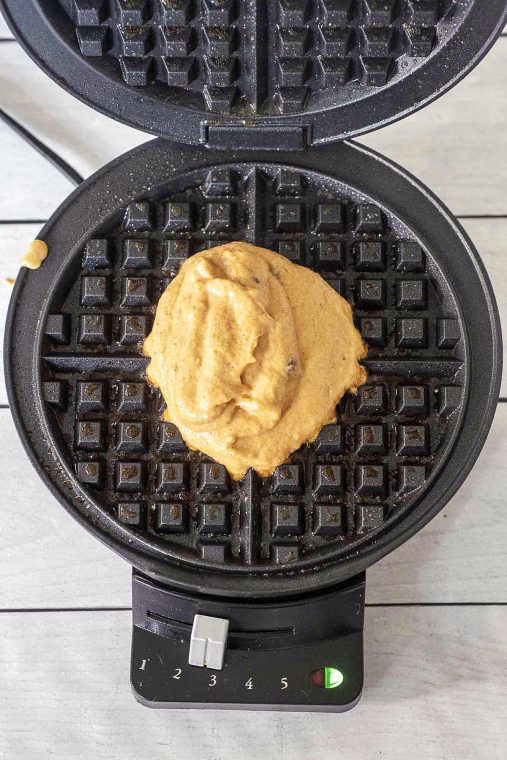 Pumpkin waffle batter in a pre-heated waffle iron.