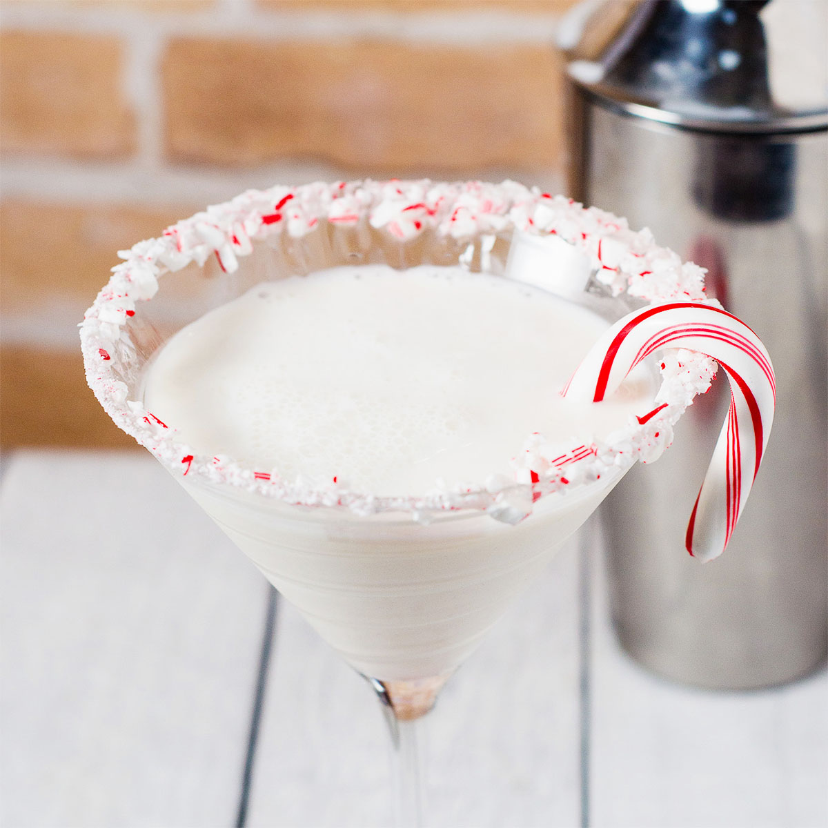 Candy cane martini garnished with a candy cane