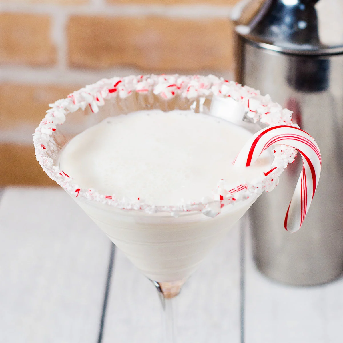 Candy cane martini garnished with a candy cane