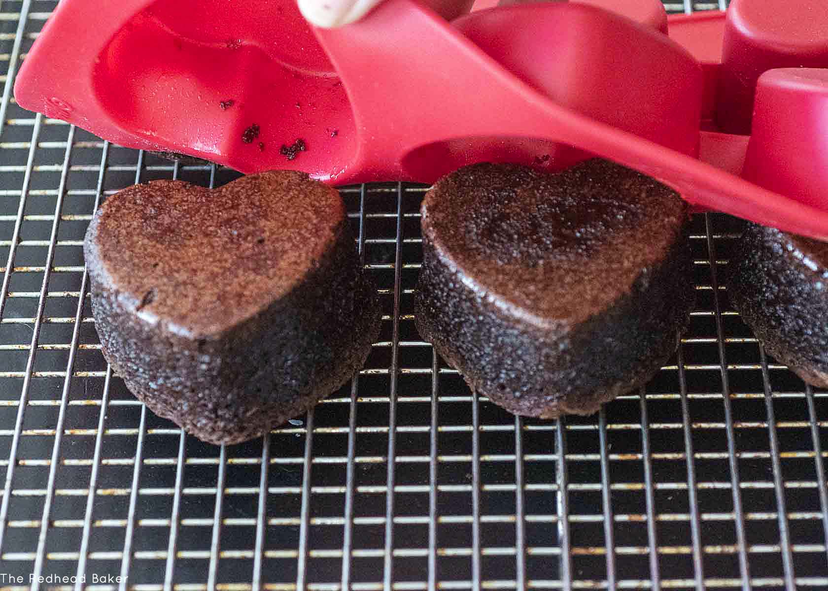 Brownie hearts being unmolded from the pan.