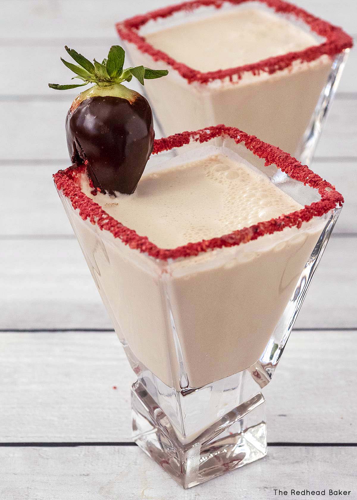 Two chocolate-covered strawberry martinis.