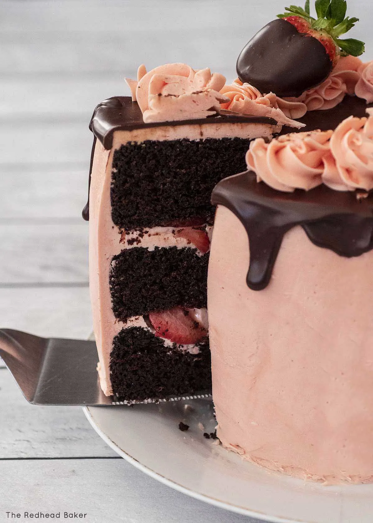 A cake server pulling a slice away from the rest of the cake. 